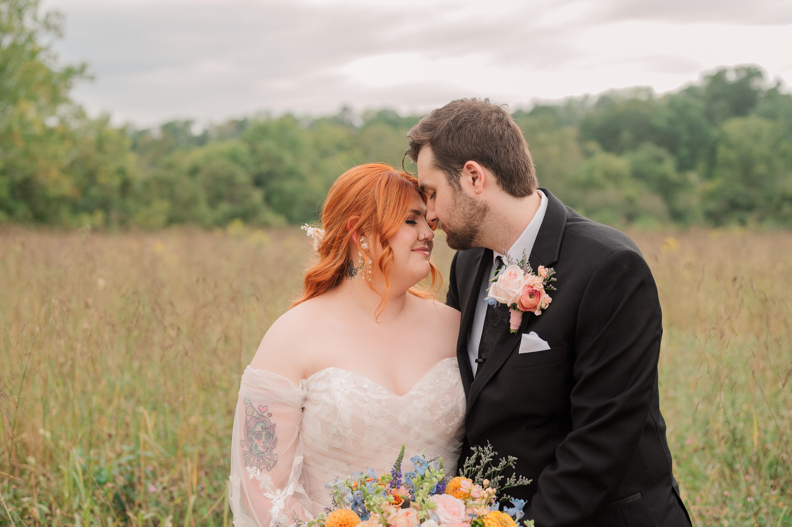 Bride and Groom stand face to face in a tall field